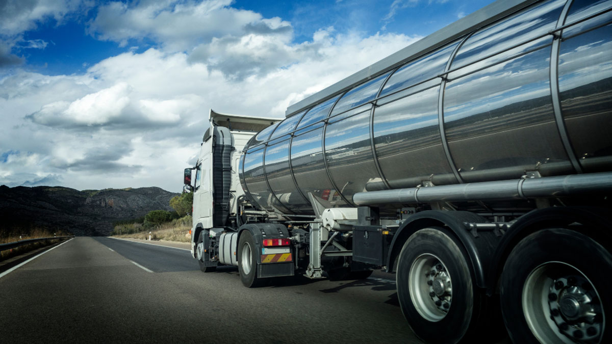 semi truck hauling wastewater driving down a highway